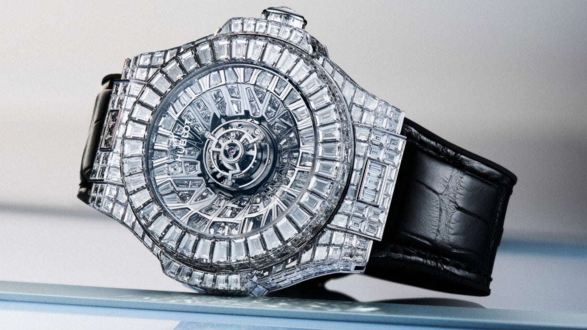 High-jewellery luxury watch featuring an intricate tourbillon movement at the center, surrounded by rows of baguette-cut diamonds across the dial, bezel and case, paired with a black leather strap.